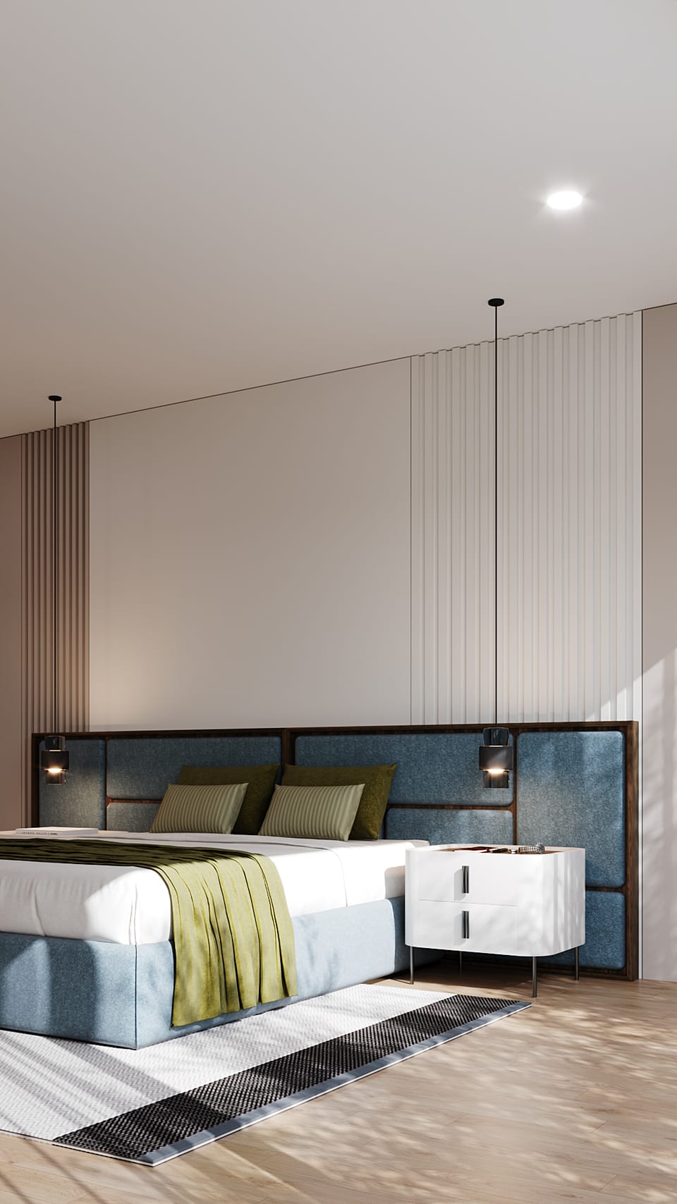 Bed with quilted blue headboard, white linen and a green throw, black pendant lights either side