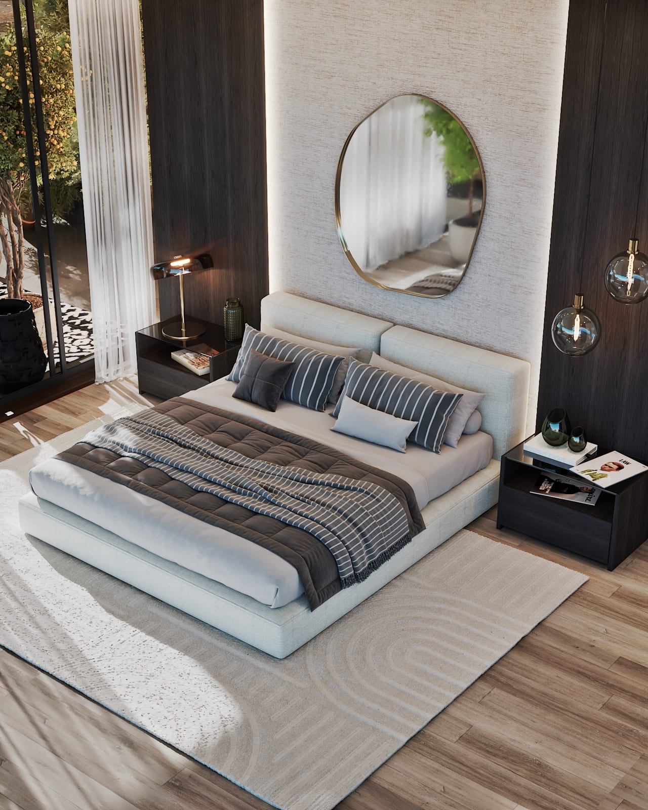 Cama baixa vista de cima com almofadas às riscas, espelho dourado e envidraçado para um terraço com árvore