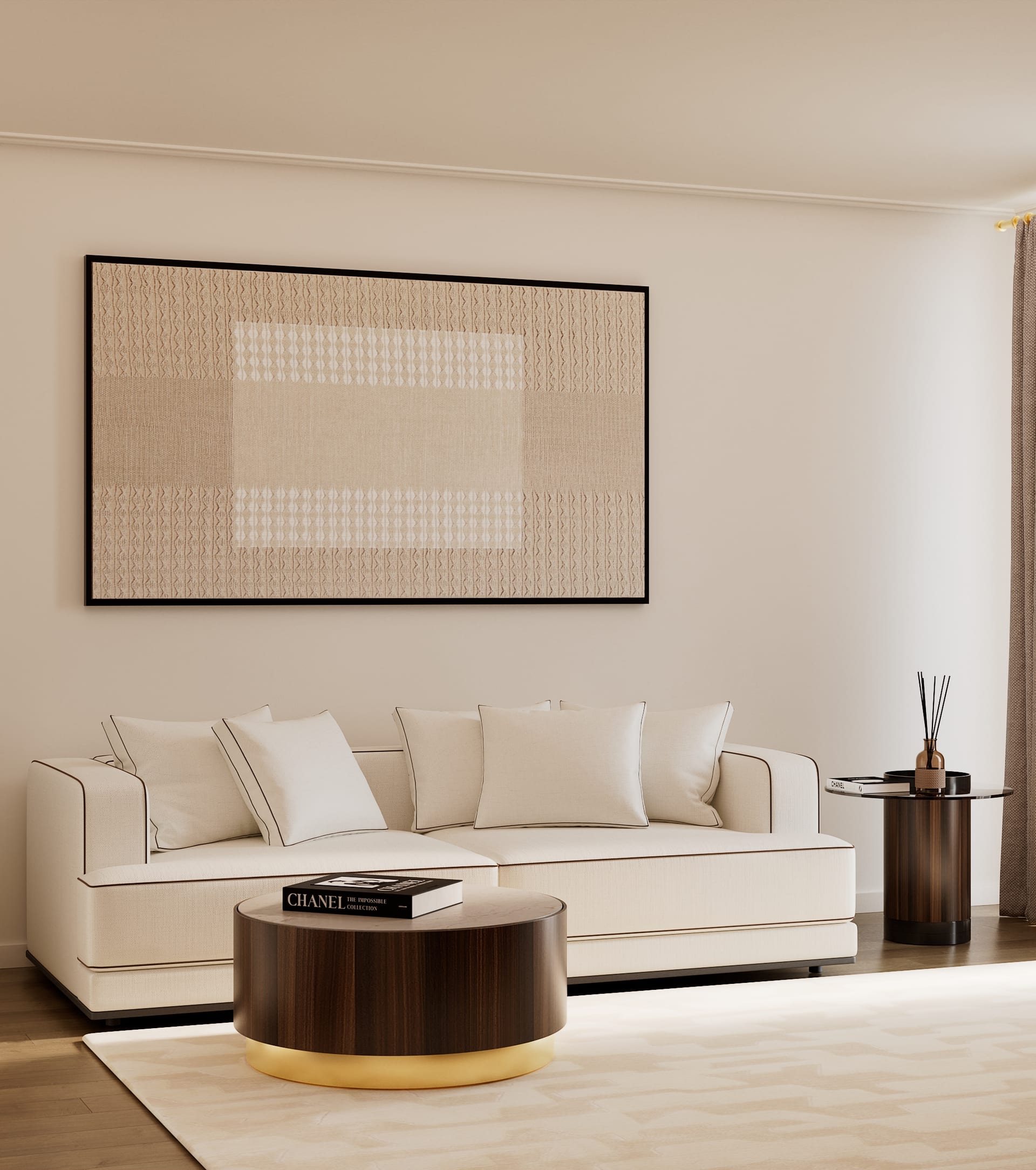 White sofa with dark piping under a beige textile artwork, with a round wood and brass coffee table