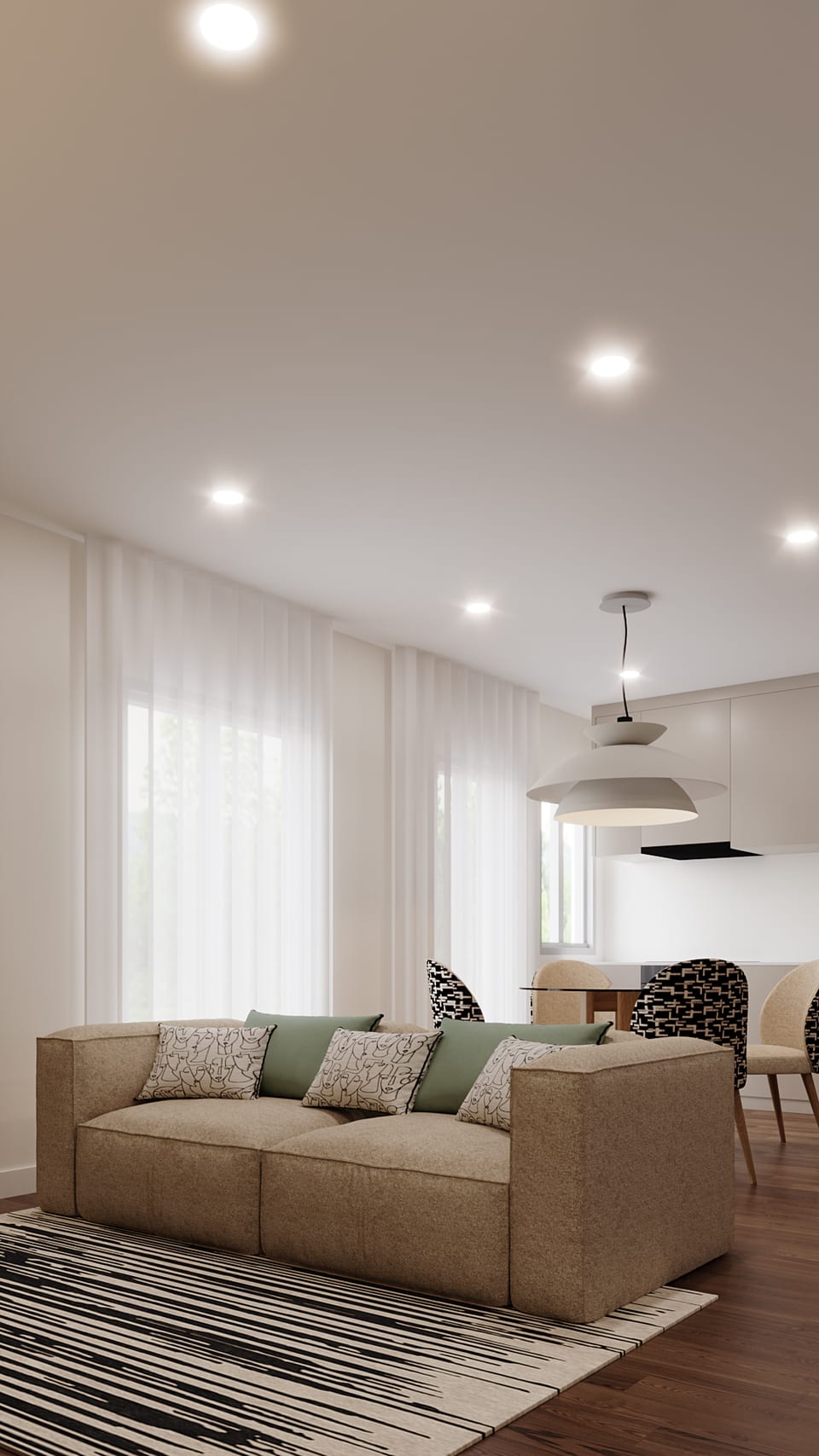 Beige sofa with green cushions and a black-and-white striped rug, with the dining area beyond